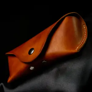 likght tan colour Sunglasses case on dark background